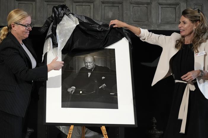 Canadian Cultural Heritage Deputy Minister, Isabelle Mondou, left, and Andrea Clark-Grignon, Head of Public Affairs, unveil a photographic portrait known as 'The Roaring Lion', of Britain's Prime Minister Winston Churchill.