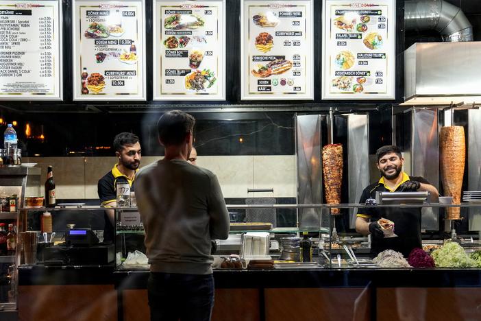 Turkish doner cooks prepare doner kebabs for customers in a doner kebab restaurant in Berlin, Germany, on Wednesday.