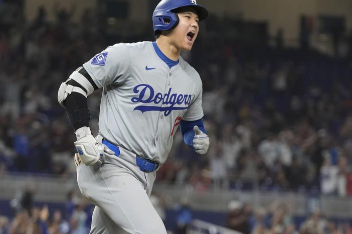 Los Angeles Dodgers' Shohei Ohtani reacts after hitting his 50th home run of the season during the seventh inning of a baseball game against the Miami Marlins on Sept. 19, 2024, in Miami. 