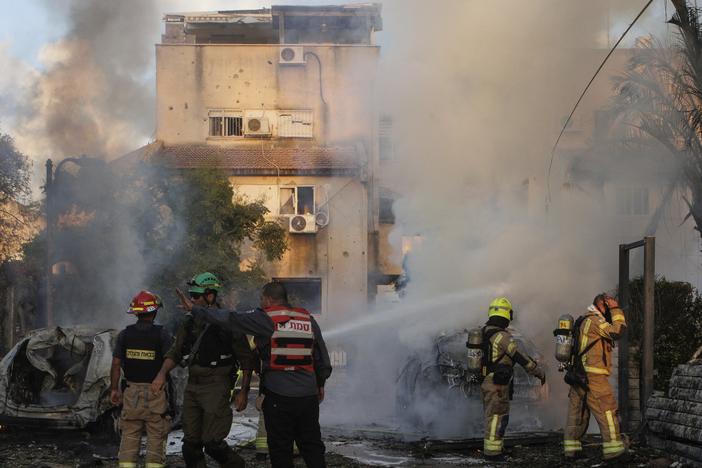 Israeli security and rescue forces work at the site hit by a rocket fired from Lebanon, in Kiryat Bialik, northern Israel, on Sunday, Sept. 22, 2024.