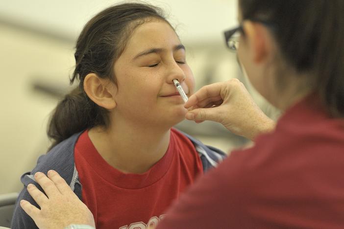 A fifth-grader receives the FluMist influenza virus vaccine in Anaheim, Calif., in 2015.