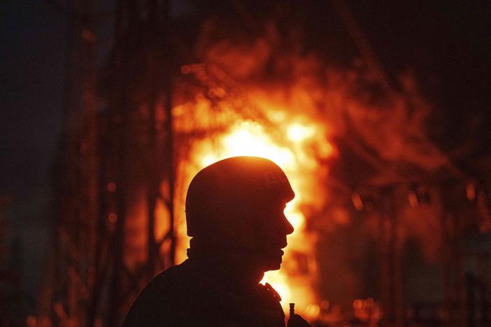 A Ukrainian rescue worker looks on at a burning electrical substation hit by a Russian bomb in the Dnipropetrovsk region in eastern Ukraine on Sept. 2. 