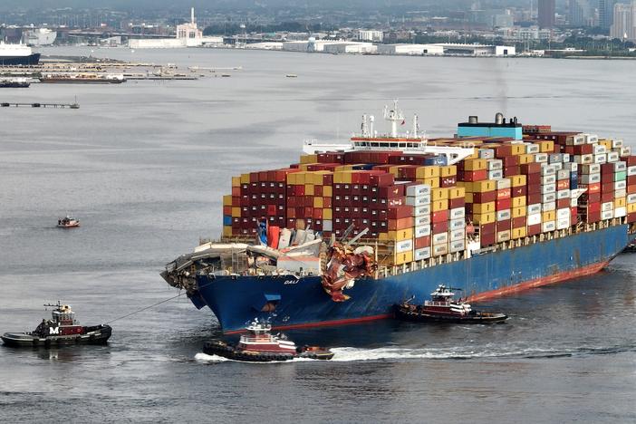 Tugboats maneuver the damaged container ship Dali through the Port of Baltimore and into the Seagirt Marine Terminal on May 20.