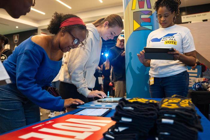 Game attendees check their voter registration status at the When We All Vote booth inside the Gateway Center Arena during an Atlanta Dream home game on Tuesday, Sept. 17, 2024.