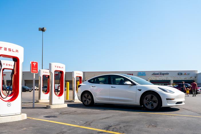 Tesla Supercharging stations are seen in a parking lot on September 16, 2024 in Austin, Texas. Electric vehicles have significant environmental advantages over similar gas-powered vehicles, but the percentage of Americans who believe that has gone down slightly over the last two years.