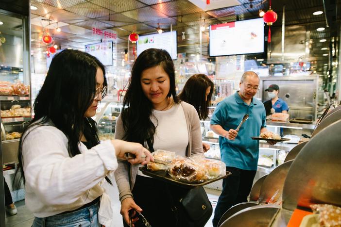  Sarah and Kaitlin Leung develop recipes with their parents for their blog, <em>The Woks of Life</em>. 