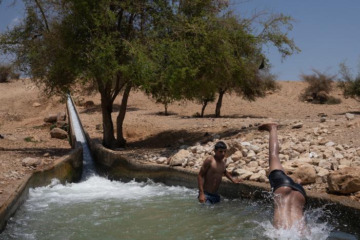 Children play in spring water in Al-Auja, a town in the occupied West Bank. 