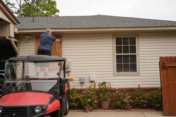 Dave McCurley boards up the windows of his home in expectation of Hurricane Helene, in Ochlockonee Bay, Fla., on Wednesday, Sept. 25.