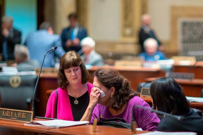 Kentucky state Sen. Karen Berg (D-Louisville), is consoled by colleagues after SB 150 passed the Senate, 29-6, at the Kentucky state Capitol in Frankfort on Feb. 16, 2023. Berg's transgender son died by suicide in December 2022. 