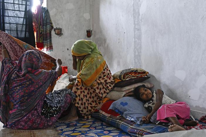 People displaced by floods rest at a relief shelter in Mohipal, Feni, a coastal district in southeast Bangladesh on August 23.