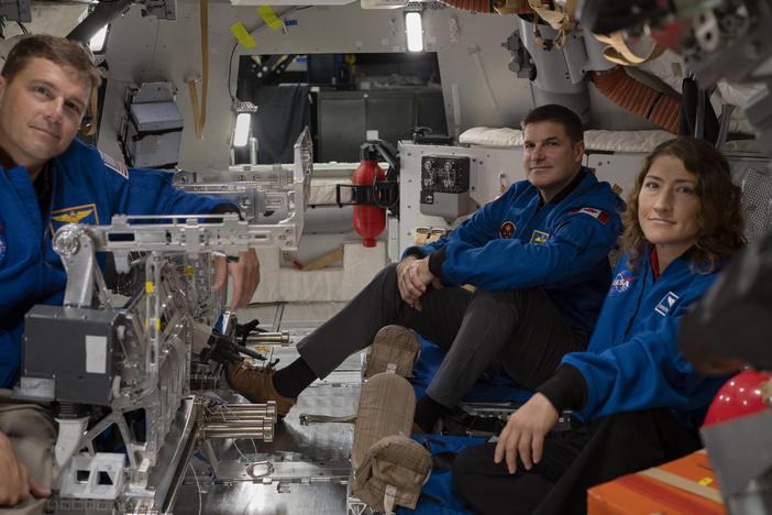 From left to right: Astronauts Reid Wiseman, Jeremy Hansen and Christina Koch settle in inside the Orion spacecraft mockup.