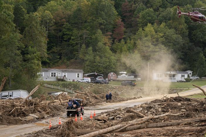 A helicopter lands in a yard near Black Mountain, N.C., in the aftermath of Hurricane Helene on Monday.