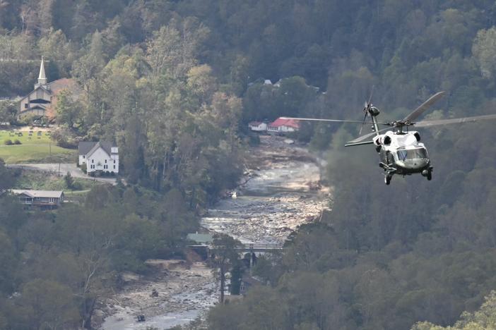 Marine One, carrying President Biden, flies above a storm-impacted area near Asheville, N.C., on Wednesday. Biden was visiting North and South Carolina to survey damage after Hurricane Helene. Social media sites, especially X, were filled with politically charged rumors and conspiracy theories about the hurricane response.