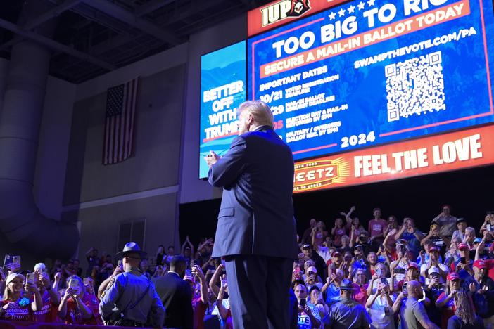 Former President Donald Trump stands on stage after speaking at a campaign event in Indiana, Pa., on Sept. 23. Behind Trump, Republicans are urged to vote in numbers that are "too big to rig."
