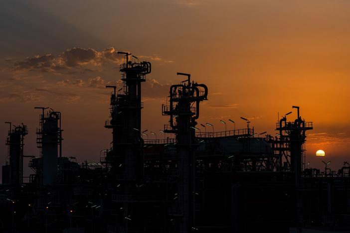 The sun shines behind a refinery in the South Pars Gas-Condensate field in Asalouyeh Seaport in Iran. Iran's oil and natural gas infrastructure is a possible target for Israeli attacks as tensions in the Mideast mount.  Oil prices have risen as a result — but remain relatively low, compared to most of 2024.