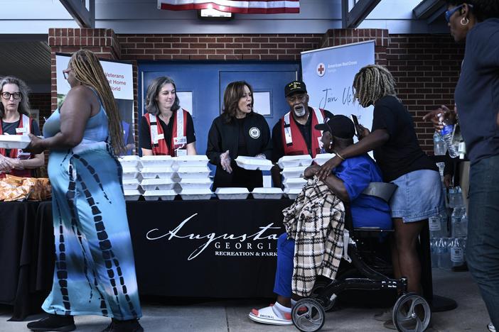 Vice President Harris hands out food to people at the Henry Brigham Community Center in Augusta, Ga., on Oct. 2, during a tour of hurricane damage in the area.