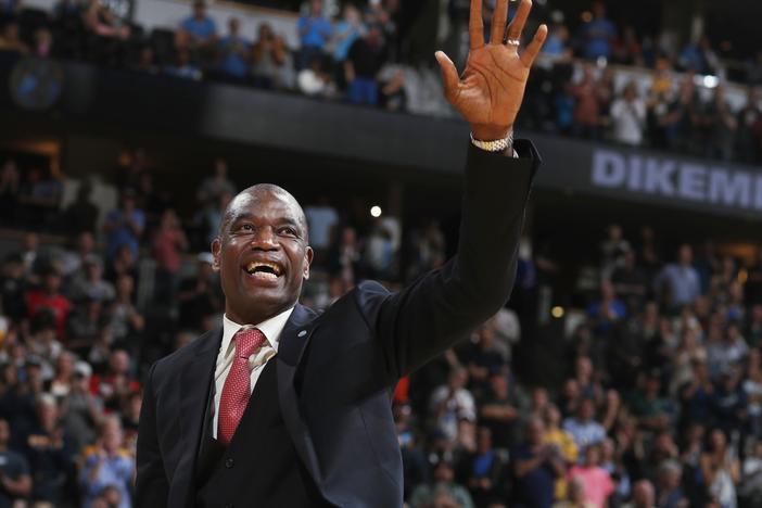 Retired Denver Nuggets center Dikembe Mutombo waves to the crowd as his jersey number was retired by the team during halftime of the Nuggets' NBA basketball game against the Portland Trail Blazers on Saturday, Oct. 29, 2016, in Denver.