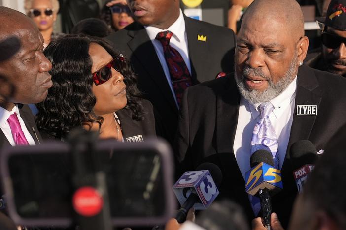Rodney Wells, right, stepfather of Tyre Nichols, speaks during a news conference with his wife RowVaughn Wells, center, and attorney Ben Crump, left, outside the federal courthouse Thursday after three former Memphis police officers were convicted of witness tampering charges in the 2023 fatal beating of their son in Memphis, Tenn.