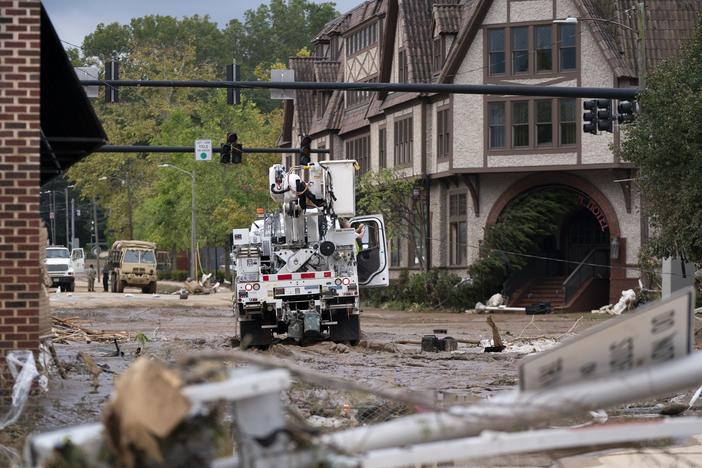 A Duke Energy lineman works on a line the Biltmore Village in the aftermath of Hurricane Helene on Sept. 28 in Asheville, N.C.