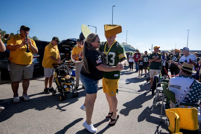 Packers fans Heather Gunnlaugsson, left, and Tim Mahoney, right, dance as the Packer Tailgate Band plays “Roll Out the Barrel” on Sunday, Sept. 29, before the Packers’ game against the Minnesota Vikings in Green Bay, Wis.