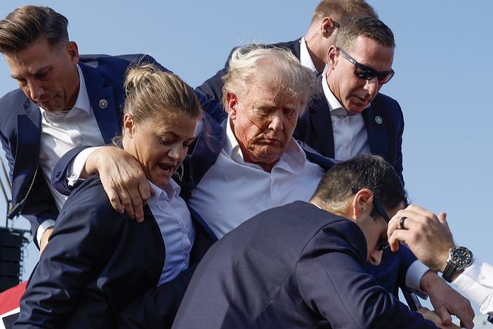 Former President Donald Trump is rushed offstage by U.S. Secret Service agents after being grazed by a bullet during a rally on July 13 in Butler, Pa.