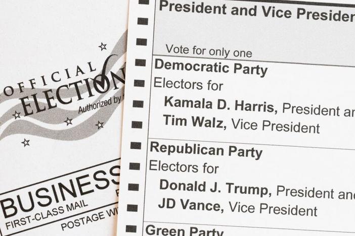 In this photo illustration, an absentee-voter mail-in ballot shows the names of the Democratic and Republican presidential and vice presidential candidates in the 2024 election.