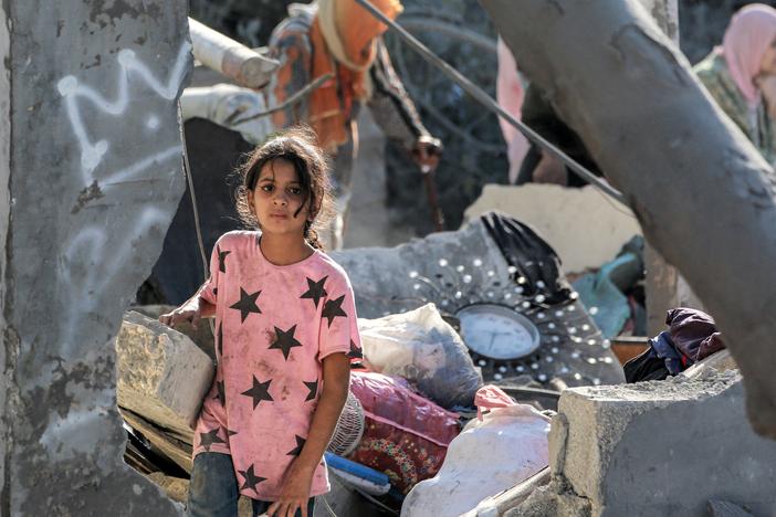 A girl walks through the rubble of a collapsed building in Khan Younis, in the southern Gaza Strip, on Oct. 2, amid the war in the Palestinian territory between Israel and Hamas.