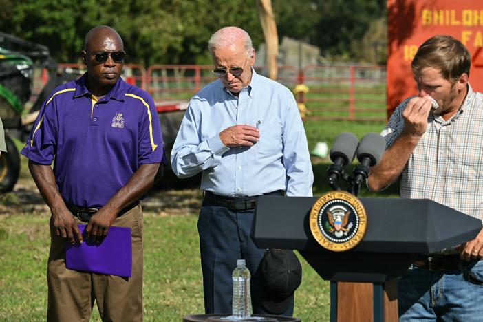 President Biden crosses himself after Buck Paulk of Shiloh Pecan Farm, in Ray City, Ga., leads a prayer on Oct. 3, 2024.