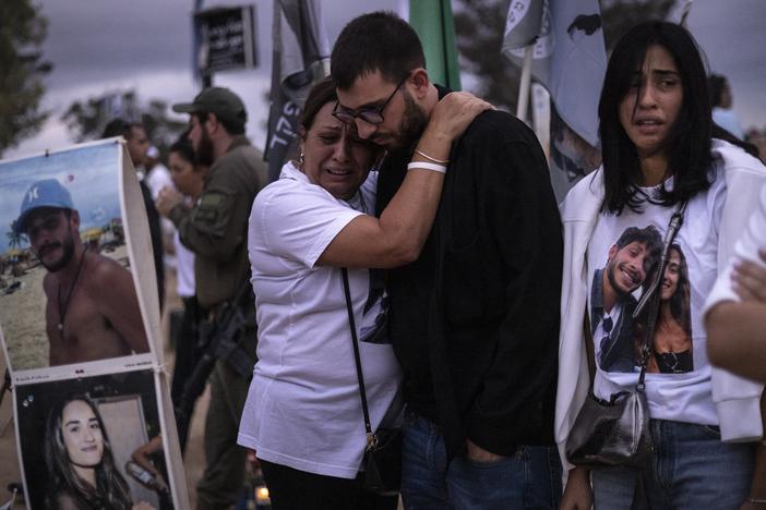 Two people embrace as relatives and supporters of Israelis killed in the Oct. 7, 2023 Hamas attack attend a ceremony at the Nova memorial near Kibbutz Reim in southern Israel on Oct. 7, 2024.