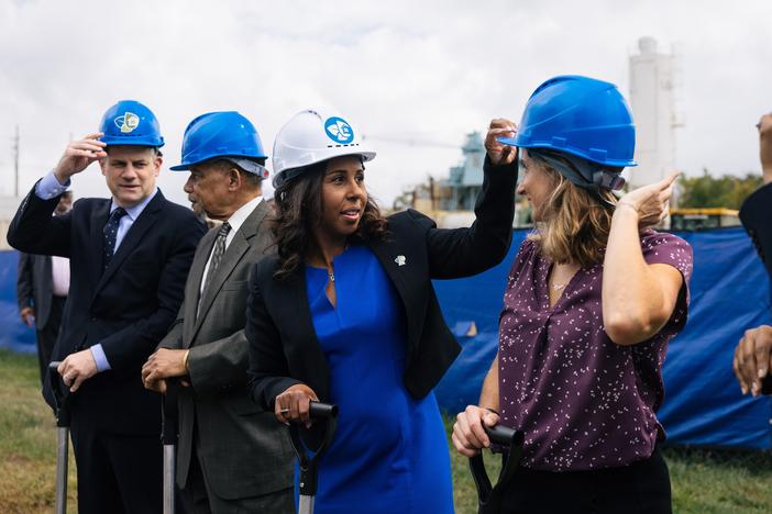 Chelsea Andrews (white hat), president and executive director of Montgomery County's<strong> </strong>Housing Opportunities Commission, adjusts Maryland State Delegate Lorig Charkoudian's hardhat during a groundbreaking ceremony for the Hillandale Gateway housing development in Silver Spring, Md. The HOC says it owns more than 9,400 apartment, townhome and single-family home rental properties and provides subsidized housing for more than 9,300 households.