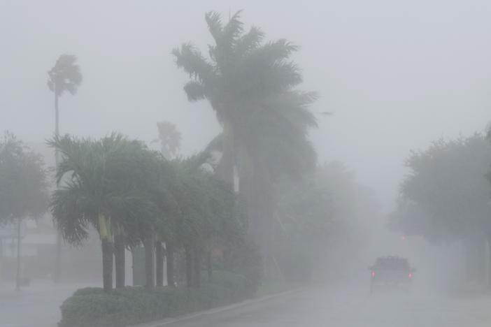 A Lee County Sheriff's officer patrols the streets of Cape Coral, Fla., as heavy rain falls ahead of Hurricane Milton on Wednesday.