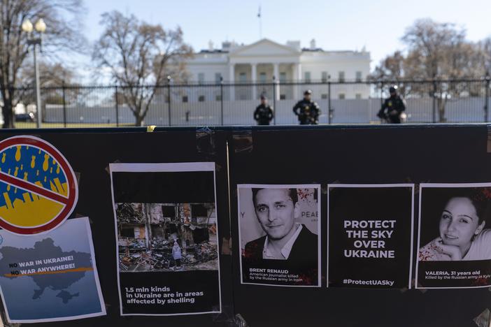 Signs and pictures of those killed, including journalists, are displayed on a fence during a protest against Russia's invasion of Ukraine in Lafayette Park near the White House on March 13, 2022, in Washington.