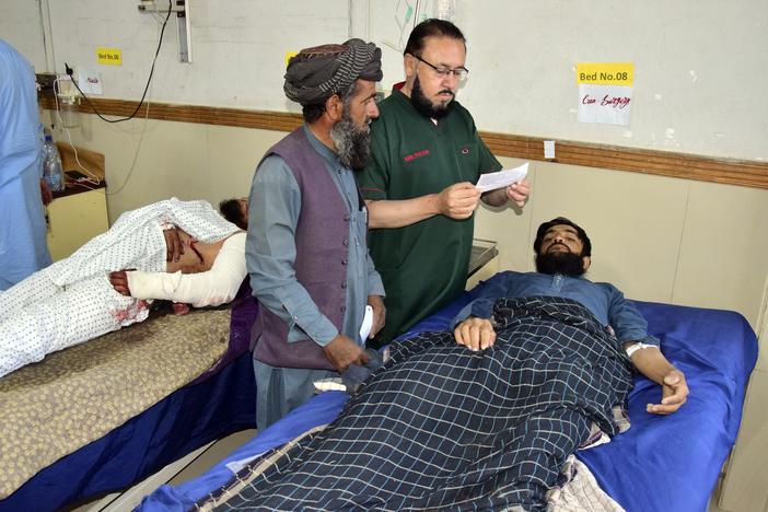 Injured men receive treatment at a hospital in Quetta, Pakistan, on Friday following the Thursday attack by gunmen in Balochistan province.