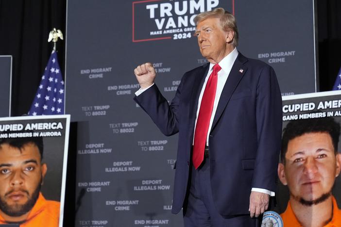 Former President Donald Trump arrives for a campaign rally at the Gaylord Rockies Resort & Convention Center in Aurora, Colo., on Friday. On stage, he was flanked by mugshots of undocumented migrants that officials have accused of crimes.