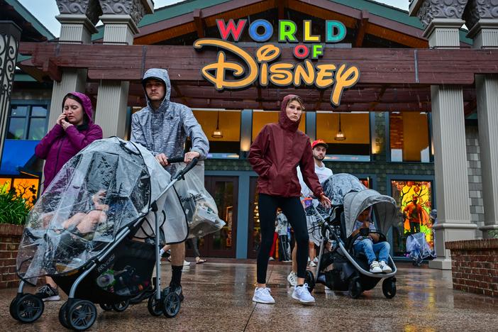 Visitors walk through the Disney Springs shopping center in Orlando ahead of Hurricane Milton's landfall in Florida on Oct. 9, 2024.