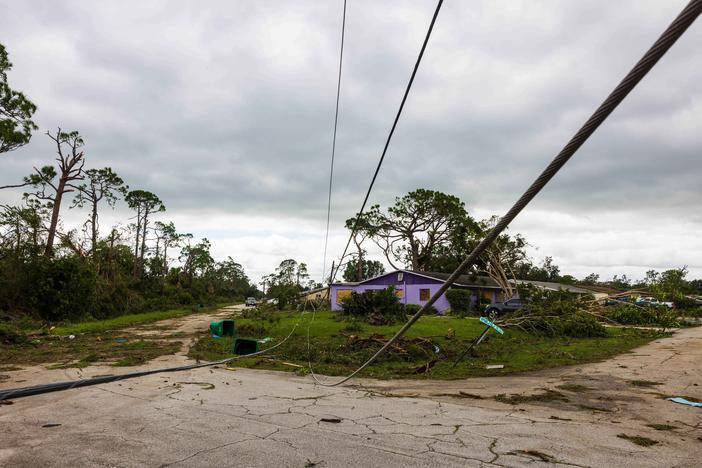 A downed power line and other damage from a tornado caused by Hurricane Milton is seen in Port St Lucie, Fla., on Thursday. The storm triggered some 126 tornado warnings in a short period of time, raising alarms about the impending large hurricane.