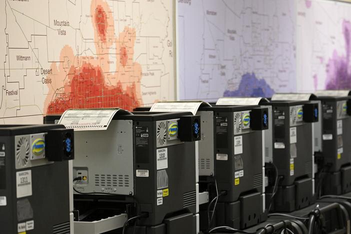Ballot printers for in-person voting are loaded with test ballots in a storage warehouse at the Maricopa County Tabulation and Election Center in Phoenix on June 3.
