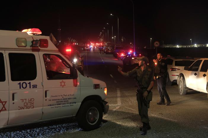 Emergency services personnel attend the scene of a drone strike launched by Hezbollah on Sunday in Binyamina, Israel.