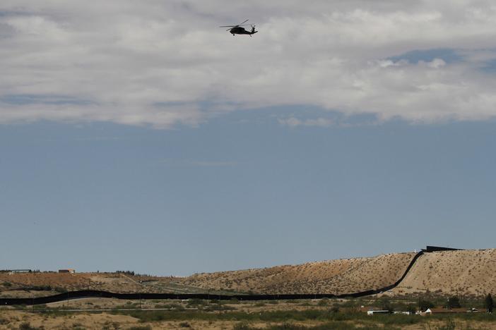 A surveillance helicopter traces a line in the sky above the Southwest border with Mexico at Sunland Park, N.M., Thursday, Aug. 22, 2024.