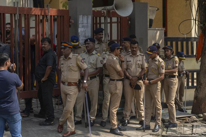 Mumbai police personnel stand guard outside the residence of Baba Siddique, a senior politician, who was shot at outside his son's office in Mumbai and later succumbed to his wounds in a hospital on Saturday night, in Mumbai, India.