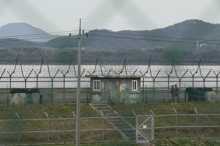 South Korean army soldiers patrol along the barbed-wire fence in Paju, South Korea, near the border with North Korea, Monday.