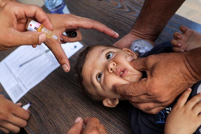 A young child is restrained before receiving a vaccination for polio in Deir el-Balah in the central Gaza Strip on Sept. 4 during the first round of a massive polio vaccination campaign led by the United Nations.