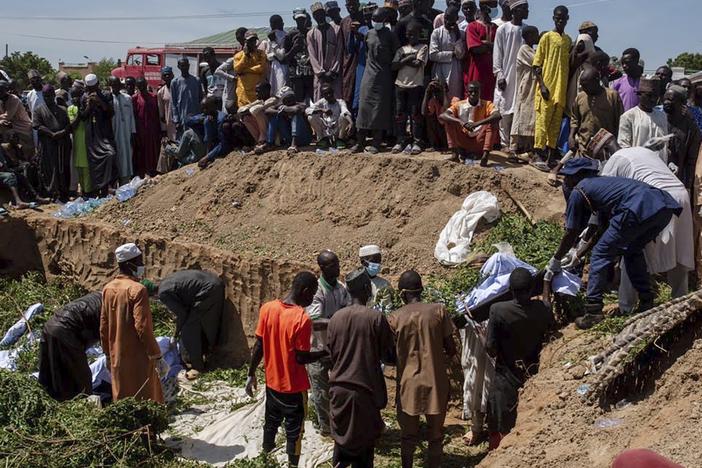 People prepare bodies for funeral following a tanker explosion in Majiya town, Nigeria, on Wednesday.