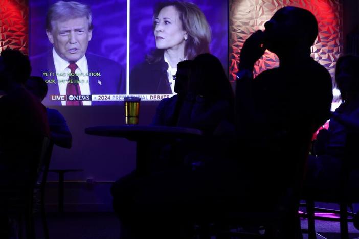 People watch the presidential debate between Vice President Harris and former President Donald Trump during a debate watch party at Penn Social on Sept. 10 in Washington, D.C.