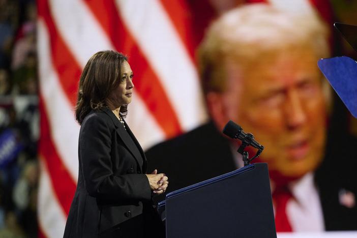 Vice President Harris plays a highlight reel of her opponent, former President Donald Trump, during a rally in Erie, Pa., on Oct. 14, 2024.