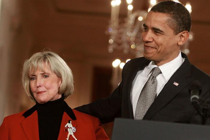 President Barack Obama stands with Lilly Ledbetter before signing the Lilly Ledbetter Fair Pay Act during an event in the East Room of the White House on Jan. 29, 2009.