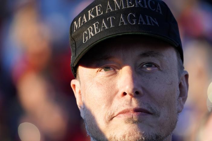 Tesla and SpaceX CEO Elon Musk listens as Republican presidential nominee former President Donald Trump speaks at a campaign event in Butler, Pa., on Oct. 5.