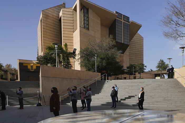 People attend a memorial service outside the Cathedral of Our Lady of Angels in Los Angeles, on Jan. 19, 2021.
