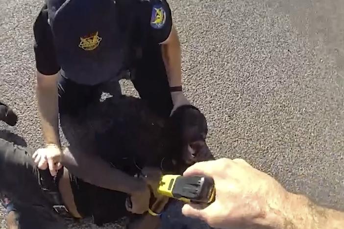 This image from Phoenix Police Department body camera footage from Aug. 19 shows Tyron McAlpin, a Black man who is deaf, being punched and shocked with a Taser by Phoenix police officers when they responded to a call that he had committed an assault at a convenience store, according to police.