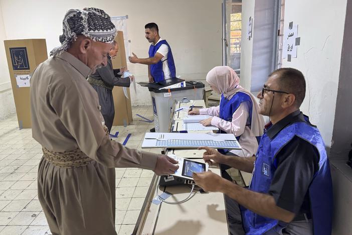 A man registers to vote during parliamentary elections of Iraq’s semi-autonomous northern Kurdish region in Irbil on Sunday.